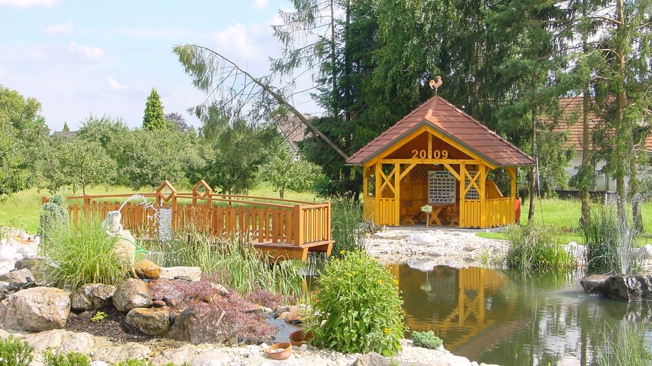 Kleiner Teich mit Holzbrücke im Ortsteil Salsach, Deutsch Goritz im Thermen- & Vulkanland Steiermark