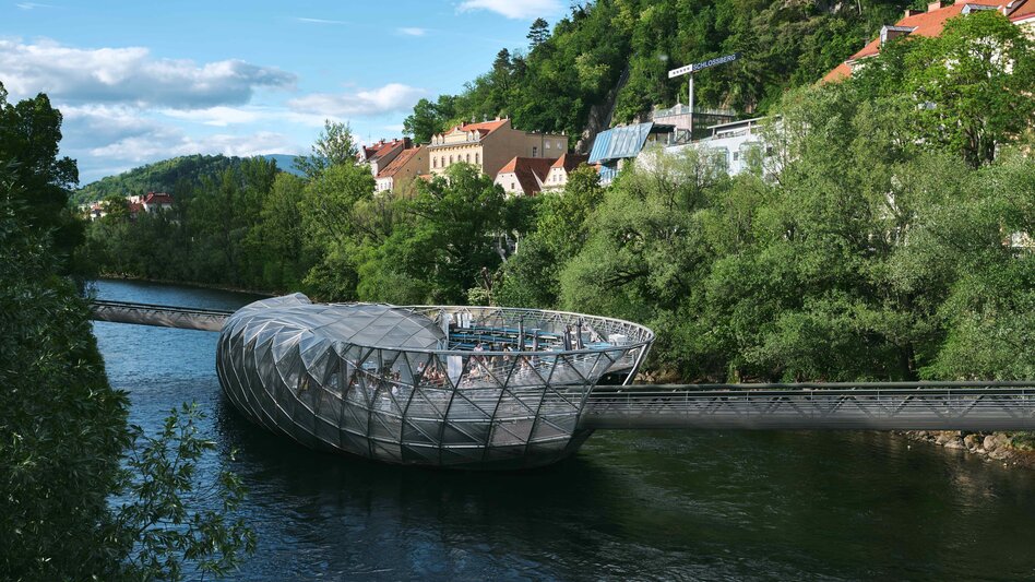 Murinsel in der Mur mit Blick auf den grünen Schlossberg in Graz.